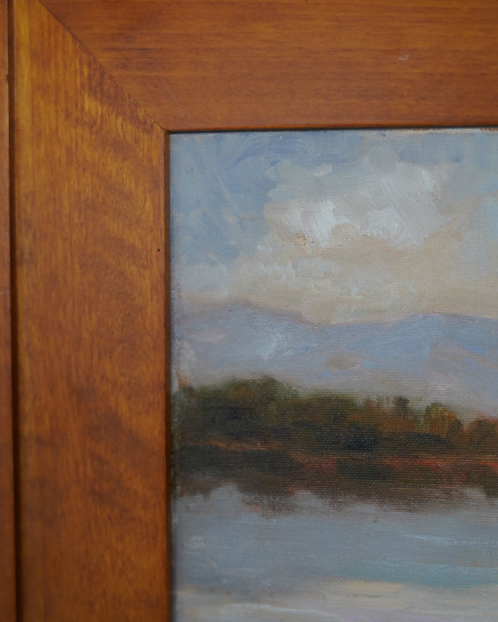 Oil painting of trees reflected in a lake with mountains, Peter Dann