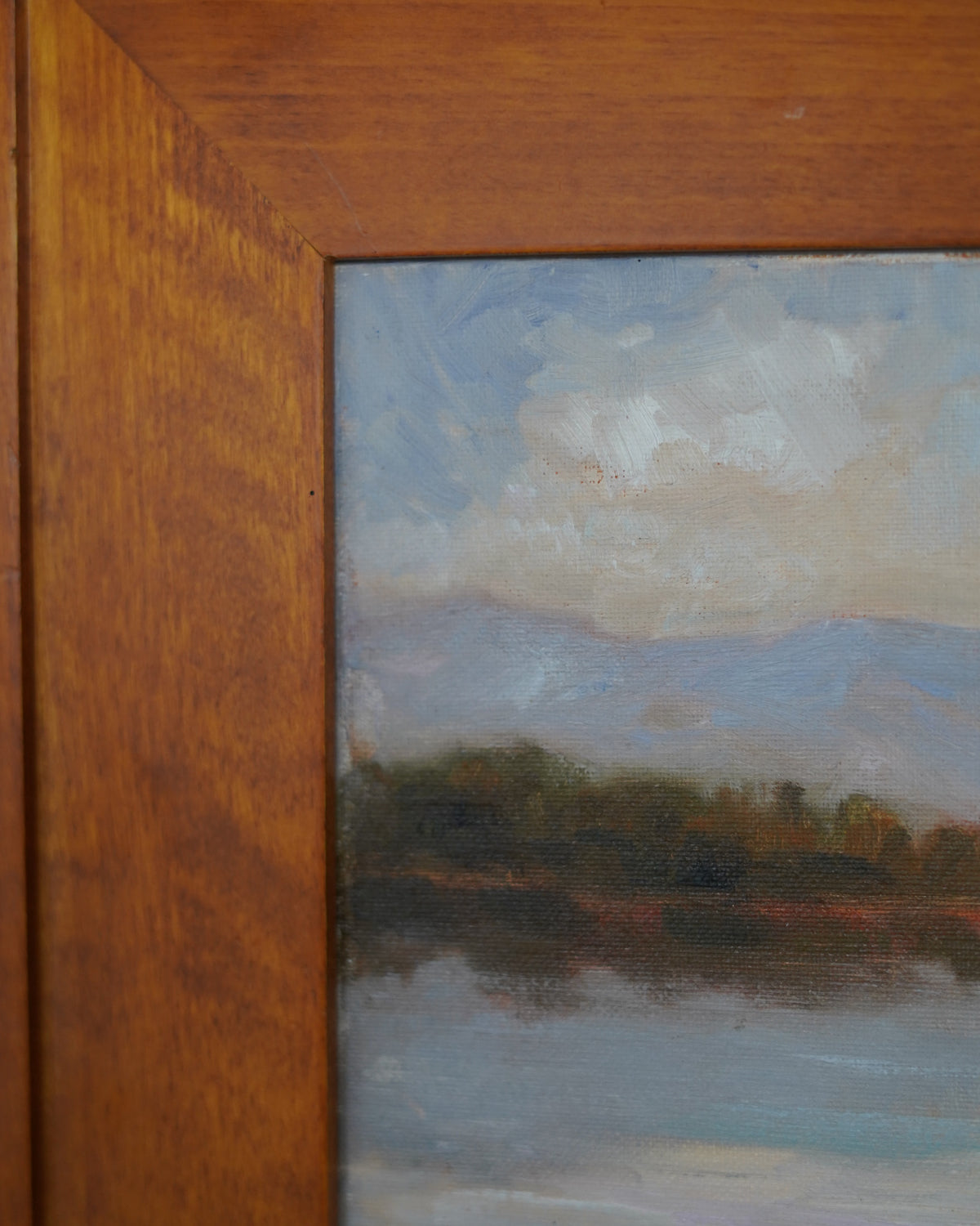 Oil painting of trees reflected in a lake with mountains, Peter Dann